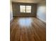 Open living space with hardwood flooring and a large window at 3358 Stonecrest Ct, Atlanta, GA 30341