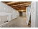 Unfinished basement featuring concrete floors and exposed ceiling at 706 Cather Ct, Stone Mountain, GA 30088