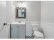 Cozy bathroom with gray vanity, mirror, toilet, and black and white checkered floor at 706 Cather Ct, Stone Mountain, GA 30088
