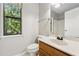 Bathroom featuring a window with trees view, a toilet and sink at 706 Cather Ct, Stone Mountain, GA 30088