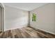 Light-filled bedroom featuring modern wood floors and neutral walls at 706 Cather Ct, Stone Mountain, GA 30088