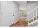 Entryway featuring wood floors that transition to carpet with views into the living room at 706 Cather Ct, Stone Mountain, GA 30088