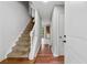 Inviting entryway featuring hardwood floors, staircase, and a view into the adjacent rooms at 706 Cather Ct, Stone Mountain, GA 30088