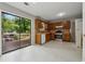 Functional kitchen with wood cabinets and a sliding glass door leading to the outside deck at 706 Cather Ct, Stone Mountain, GA 30088