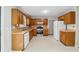 Well-lit kitchen with wood cabinets, white appliances, and plenty of counter space at 706 Cather Ct, Stone Mountain, GA 30088