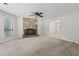 Bright living room with a stone fireplace, large windows, and neutral carpet at 706 Cather Ct, Stone Mountain, GA 30088