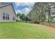 Lush green backyard with privacy fence and view of the home's siding at 4512 Evan Ct, Hoschton, GA 30548