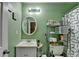 Cozy bathroom featuring a sink, toilet, and shower with decorative elements at 4512 Evan Ct, Hoschton, GA 30548