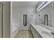 Bathroom featuring double sinks with large mirrors, bright lighting, and a large bathtub on the left at 4512 Evan Ct, Hoschton, GA 30548