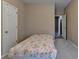Bedroom with neutral walls, a bed with floral pattern, and carpeted floors for a comfortable space at 4512 Evan Ct, Hoschton, GA 30548