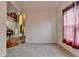 Carpeted bedroom with a view to the foyer through the doorway and a window with curtains at 4512 Evan Ct, Hoschton, GA 30548