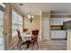 Cozy dining area featuring a round table, wooden chairs, and white kitchen cabinets at 4512 Evan Ct, Hoschton, GA 30548