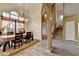 Inviting dining room with large window, wood floors, elegant chandelier, and adjacent staircase at 4512 Evan Ct, Hoschton, GA 30548