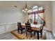 Formal dining room with a stylish chandelier and a large window for natural light at 4512 Evan Ct, Hoschton, GA 30548