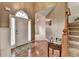 Elegant foyer featuring hardwood floors, a staircase, and a view into the living area at 4512 Evan Ct, Hoschton, GA 30548
