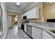 Stylish kitchen with stainless steel appliances and sleek countertops, leading to dining area at 4512 Evan Ct, Hoschton, GA 30548