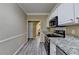 Well-appointed kitchen with stainless steel appliances, light countertops, and access to dining area at 4512 Evan Ct, Hoschton, GA 30548