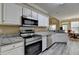 Bright kitchen boasts stainless appliances, white cabinets, and a dining area, perfect for entertaining at 4512 Evan Ct, Hoschton, GA 30548