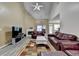 Bright living room with vaulted ceilings, fireplace, and views into the kitchen and dining area at 4512 Evan Ct, Hoschton, GA 30548