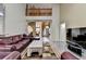 Open-concept living area with hardwood floors and second-story balcony at 4512 Evan Ct, Hoschton, GA 30548
