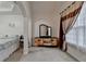 Bright main bedroom with sitting area, natural light, and neutral decor at 4512 Evan Ct, Hoschton, GA 30548