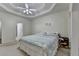 Large main bedroom featuring a tray ceiling, neutral decor, and carpeted floors at 4512 Evan Ct, Hoschton, GA 30548