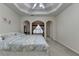 Bright main bedroom with a tray ceiling and a cozy sitting area at 4512 Evan Ct, Hoschton, GA 30548