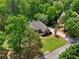 Secluded home nestled among mature trees offering privacy, while still featuring a well-manicured lawn and established landscaping at 5030 Princeton Trce, Cumming, GA 30041