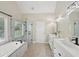 Modern bathroom with dual vanities, a tub, a shower, and neutral finishes at 5030 Princeton Trce, Cumming, GA 30041
