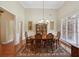 Elegant dining room with wood table, chandelier, and large windows for natural light at 5030 Princeton Trce, Cumming, GA 30041