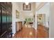 Spacious foyer with hardwood floors, high ceilings, decorative art, and views into the living spaces at 5030 Princeton Trce, Cumming, GA 30041