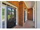 Close-up of the inviting brick porch with a glass front door, white trim, and brick accents at 5030 Princeton Trce, Cumming, GA 30041