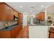Traditional kitchen with hardwood floors, wood cabinets, tile backsplash, and stainless steel appliances at 5030 Princeton Trce, Cumming, GA 30041
