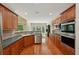 Spacious kitchen with wood cabinets, stainless steel appliances, and natural light at 5030 Princeton Trce, Cumming, GA 30041