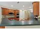 Kitchen with dark countertops, wood cabinets, stainless appliances, and recessed lighting at 5030 Princeton Trce, Cumming, GA 30041