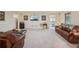 Expansive living room with plush carpeting and cozy leather seating for relaxed living at 5030 Princeton Trce, Cumming, GA 30041