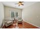 Bright sitting area featuring hardwood floors, neutral walls, and two comfortable armchairs for relaxing at 5030 Princeton Trce, Cumming, GA 30041