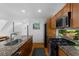 Modern kitchen with stainless steel appliances, wood cabinets, and window with backyard view at 920 Memorial Se Dr # 11, Atlanta, GA 30316