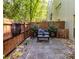 Cozy patio features stone pavers, a wood fence, and lush greenery at 920 Memorial Se Dr # 11, Atlanta, GA 30316