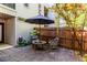Cozy patio with pavers, wooden fence, small table, and chairs under an umbrella at 920 Memorial Se Dr # 11, Atlanta, GA 30316