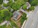 Beautiful aerial view of a brick home surrounded by lush greenery and well-maintained landscaping in a desirable neighborhood at 100 Barnard Pl, Atlanta, GA 30328