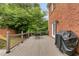 Back deck features outdoor seating and a grill with a brick house exterior at 100 Barnard Pl, Atlanta, GA 30328