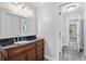 Elegant bathroom featuring a vanity with granite countertop and a large mirror at 100 Barnard Pl, Atlanta, GA 30328