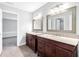 Bathroom featuring double vanities with granite countertops and framed mirrors at 100 Barnard Pl, Atlanta, GA 30328