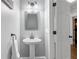 Chic powder room features a pedestal sink, modern fixtures, and a stylish mirror at 100 Barnard Pl, Atlanta, GA 30328