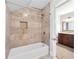 Bathroom featuring tiled shower, niche, and granite-topped vanity at 100 Barnard Pl, Atlanta, GA 30328