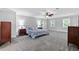 Spacious bedroom with ceiling fan, two dressers and two windows allowing natural light at 100 Barnard Pl, Atlanta, GA 30328