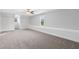 Bright bedroom with window seating, neutral walls, plush carpeting, and a ceiling fan at 100 Barnard Pl, Atlanta, GA 30328
