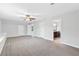 Bright bedroom featuring neutral walls, plush carpeting, ceiling fan, and ensuite bathroom at 100 Barnard Pl, Atlanta, GA 30328