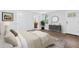 Comfortable bedroom featuring hardwood floors and a calming decor, complete with a dresser and mirror at 100 Barnard Pl, Atlanta, GA 30328